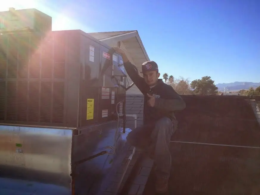 HVAC technician performing Boiler Repair on a rooftop unit in Ohio